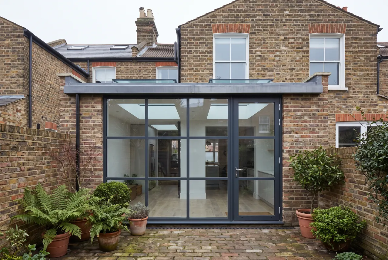 A side return infill extension on a Victorian terrace with rooflights and a full height glazed screen