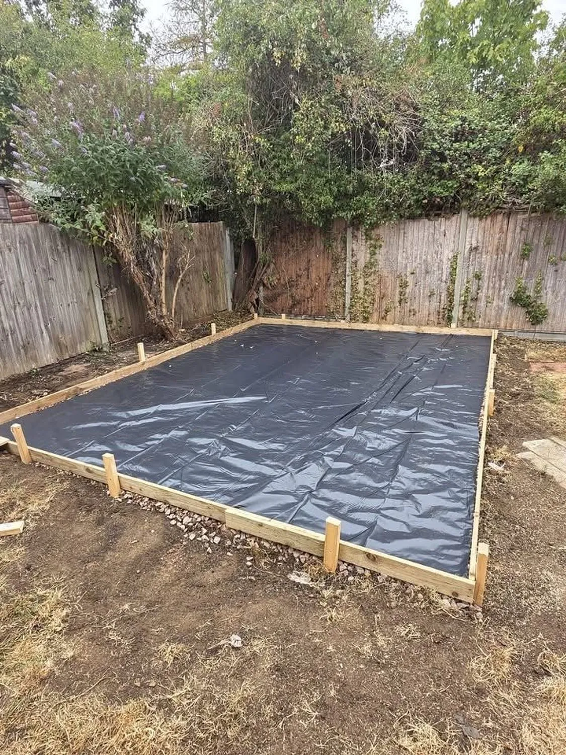 Timber shuttering and damp proof membrane laid ready for a concrete base