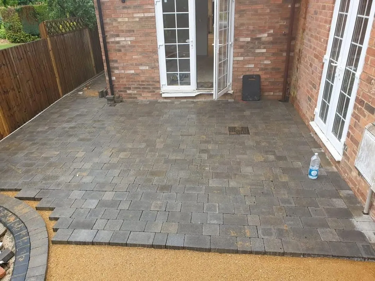 Finished block paved rear patio running up to French doors