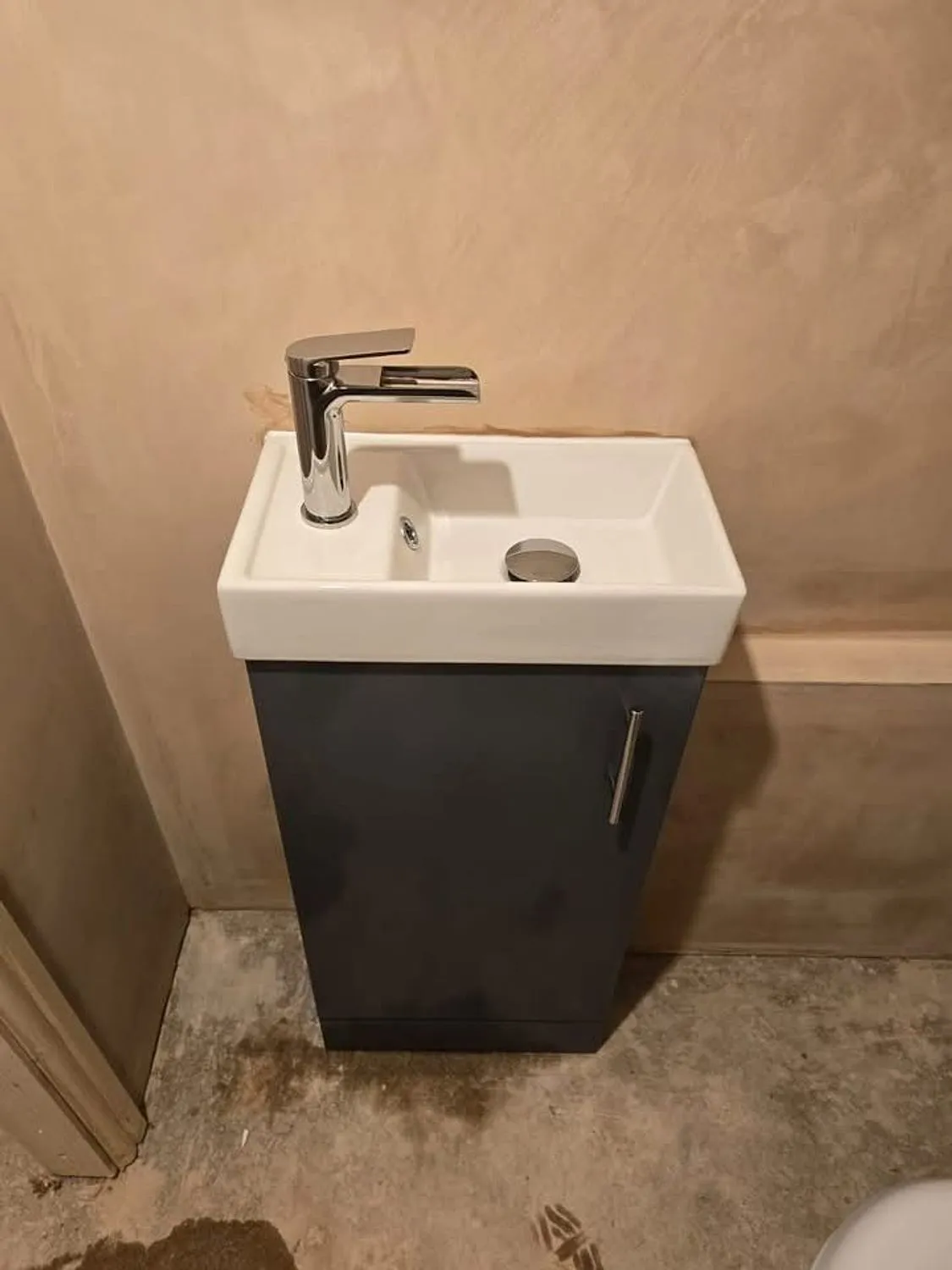 Compact vanity basin fitted in a new downstairs cloakroom