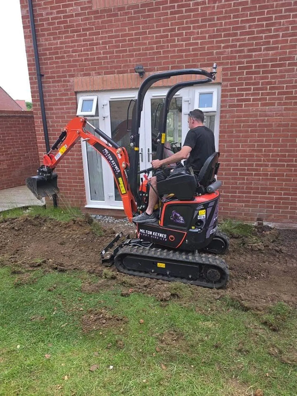 Mini excavator stripping ground at the rear of a house