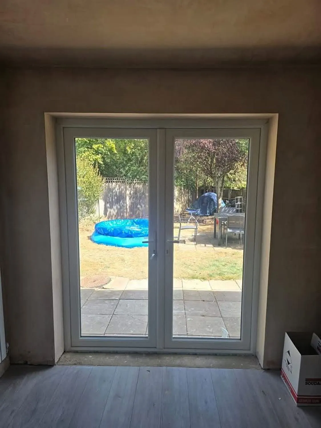 New French doors fitted into a formed opening, seen from inside