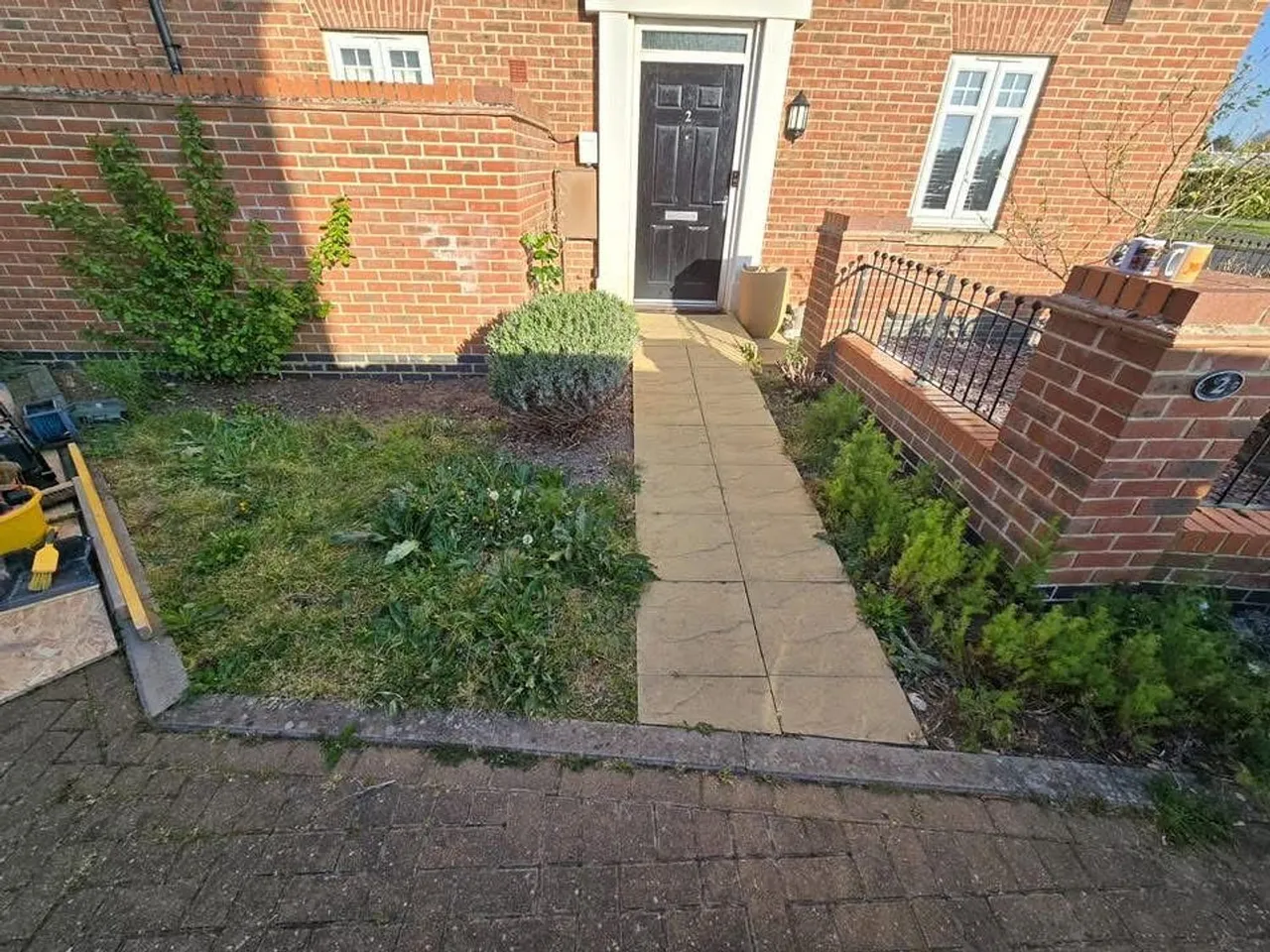 New paved front path and steps running up to a front door