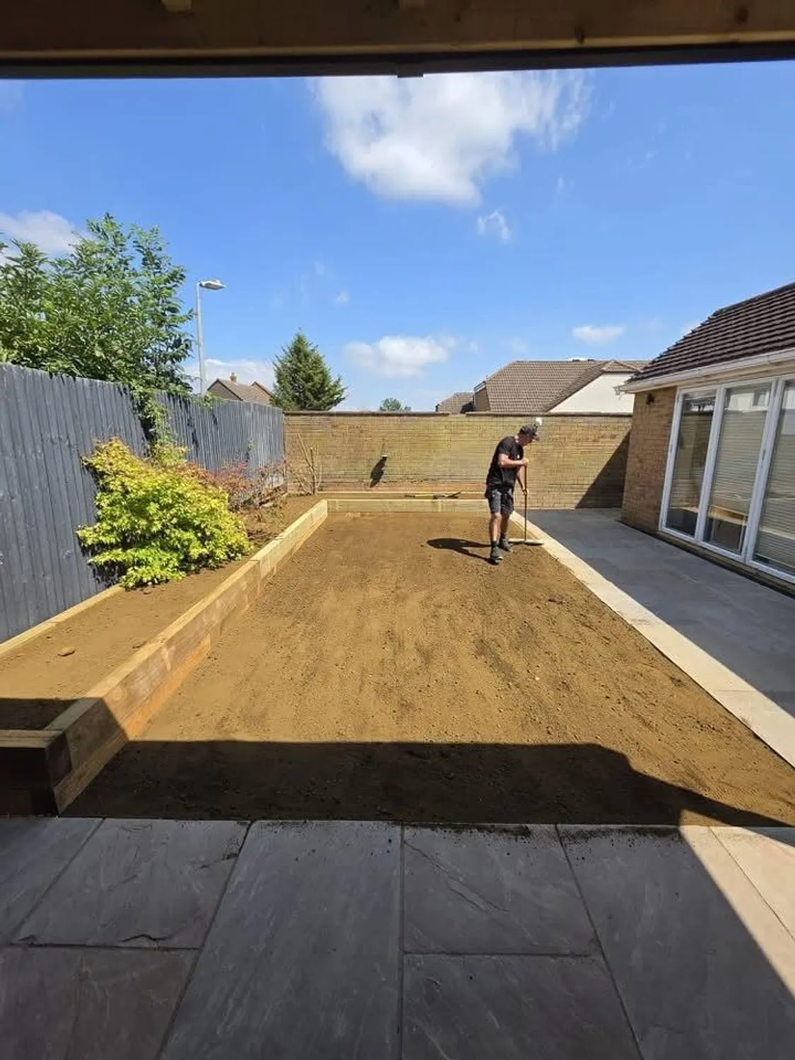 Rear garden levelled and prepared between new sleeper retaining walls
