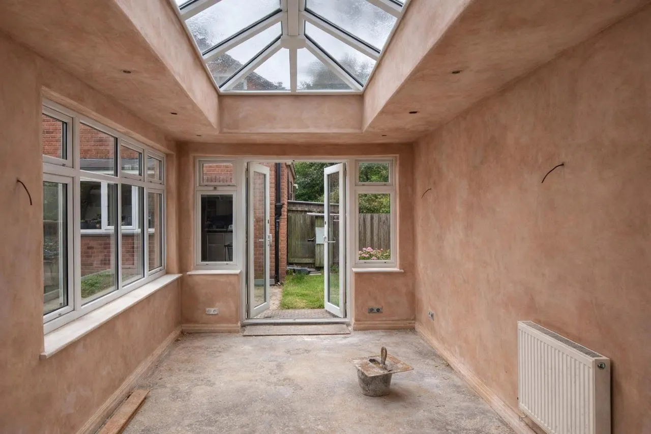 Rear room with a lantern roof and French doors, plastered and ready for decoration