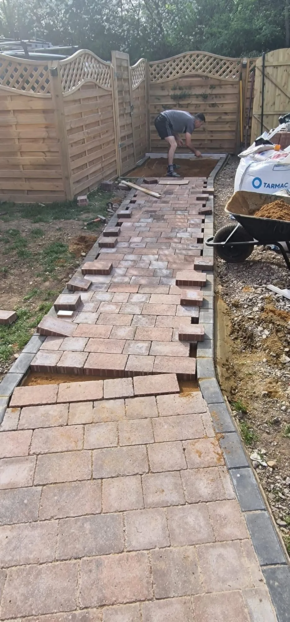 Block paving being laid to a running bond along a new path