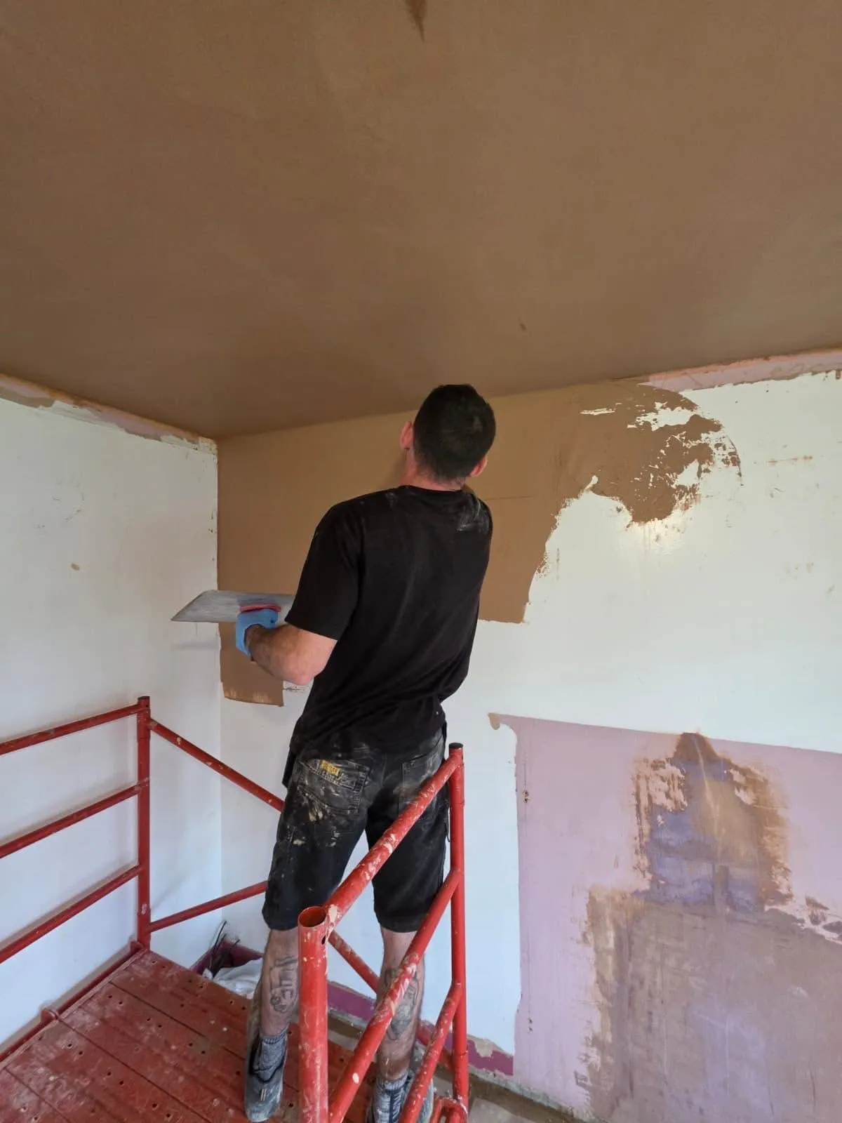 Skimming a wall by hand during a full property renovation