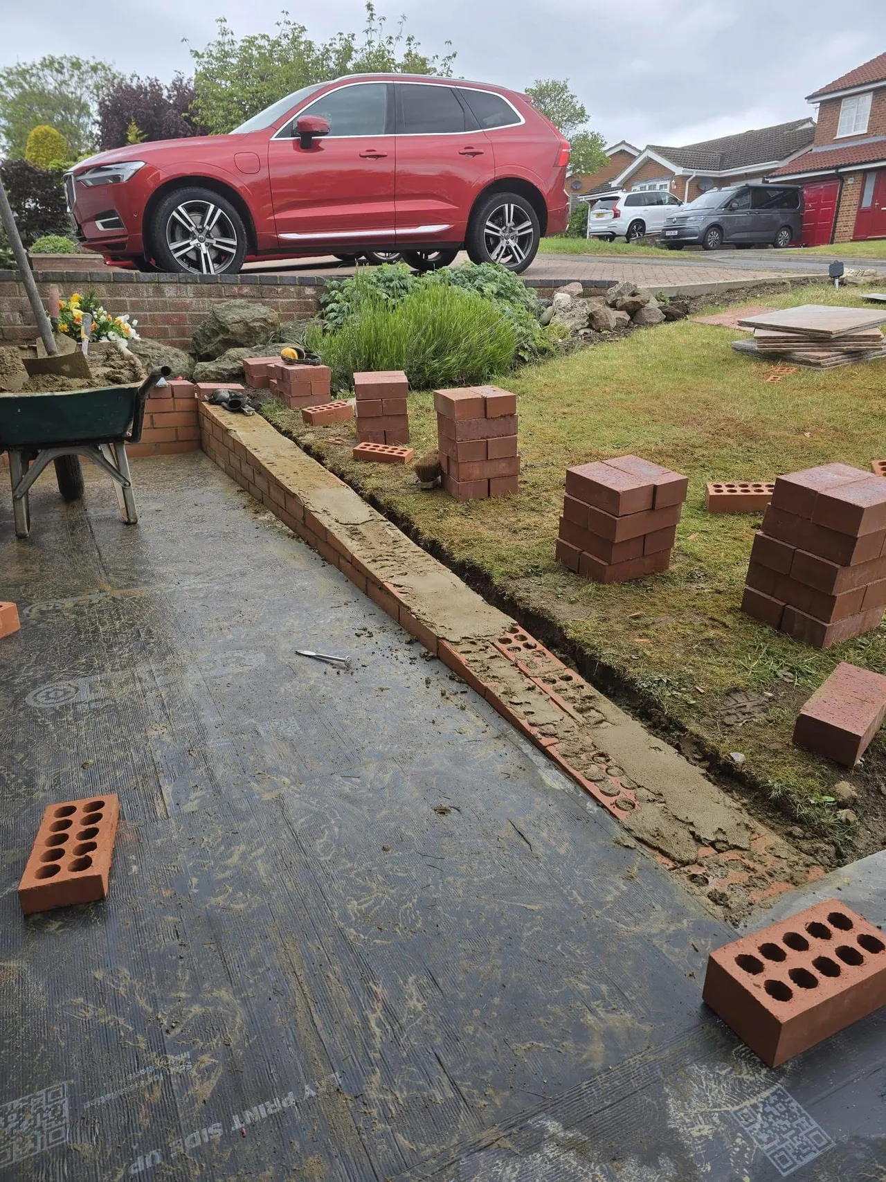 Brick edging being laid along a new side path