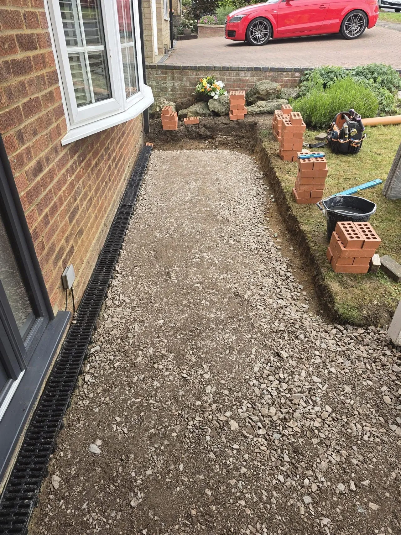 Side path excavated and prepared with sub base and brick edging set out