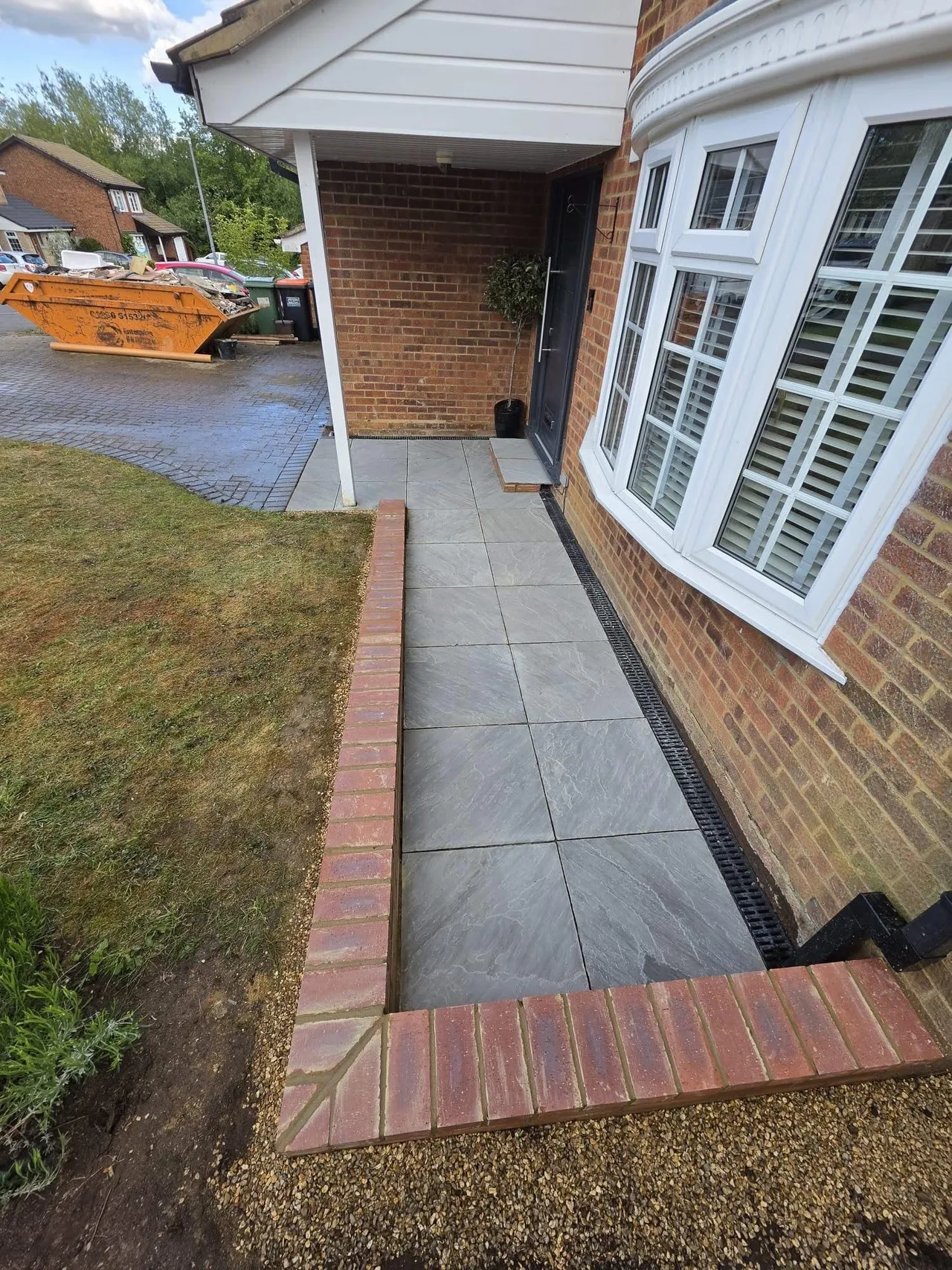 Finished side path in slate paving with a brick retaining edge and reinstated lawn