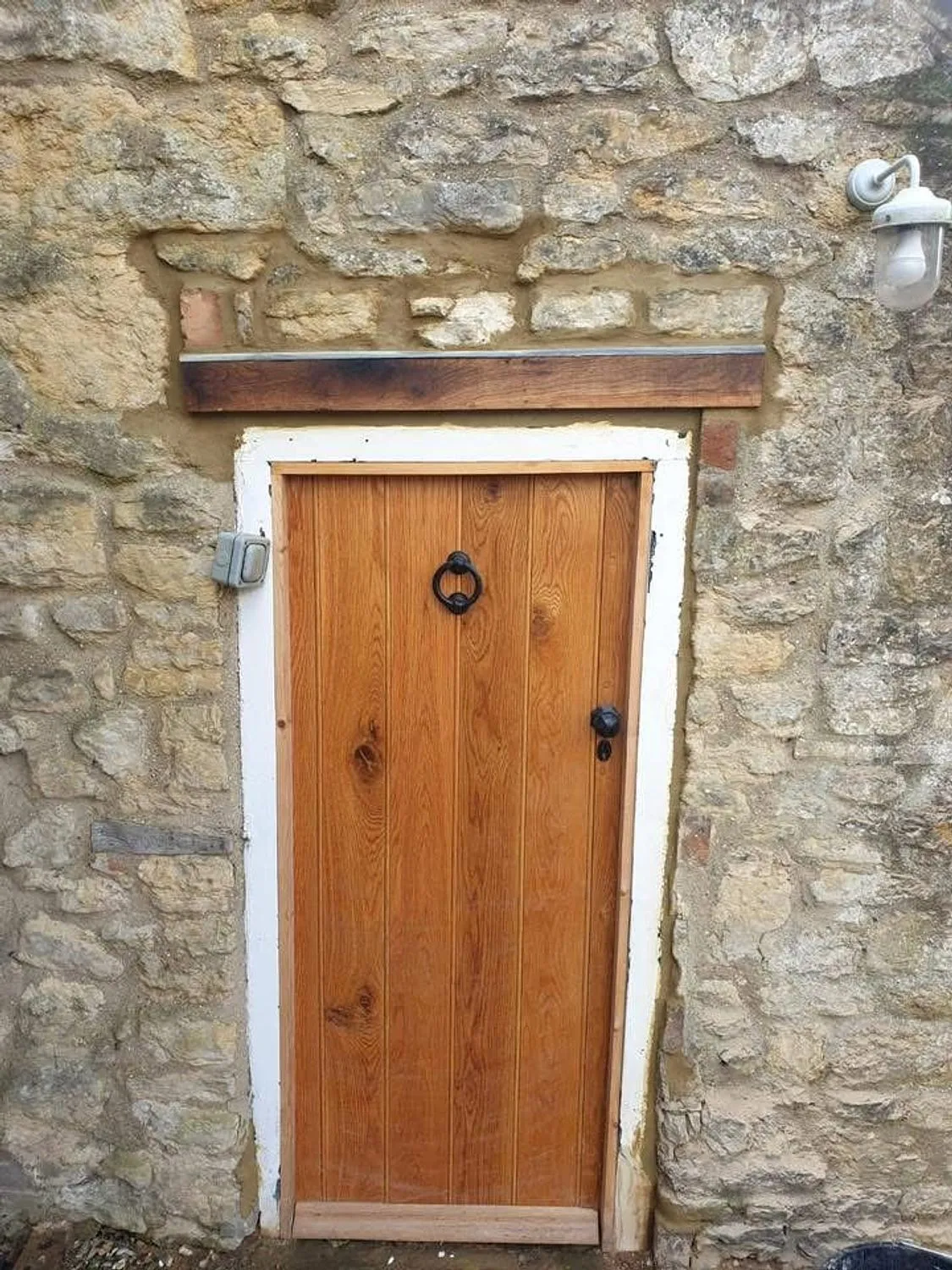 Finished stone opening with a new oak lintel and solid oak door