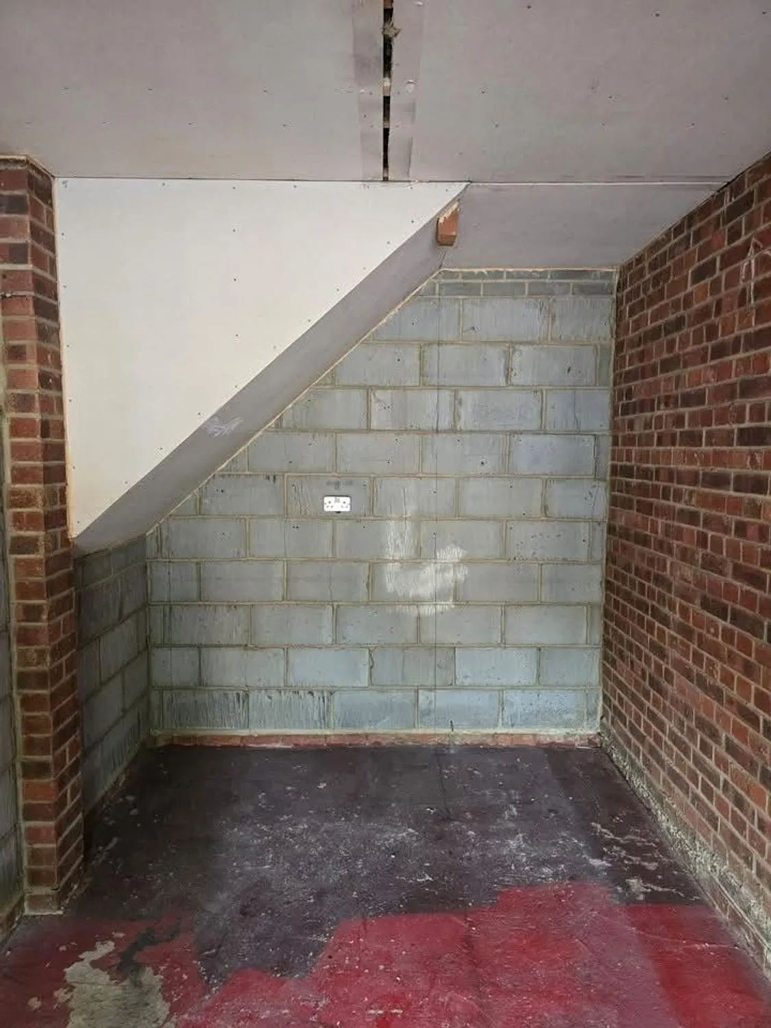 Under stairs space stripped back to blockwork and brick